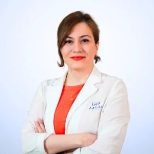 Dr. Mehri Maghsoudi, Specialist Dermatologist at Azura Clinic Muscat, wearing a white medical coat for professional dermatology, skin care, and aesthetic treatments
