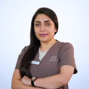 Ms. Fatemeh, Head Nurse at Azura Clinic Muscat, wearing Azura medical scrubs for professional patient care, clinical support, and aesthetic treatment assistance
